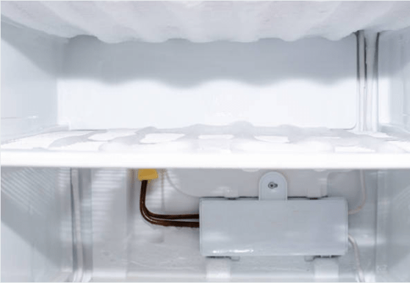 freezer compartment with frozen ice and evaporator